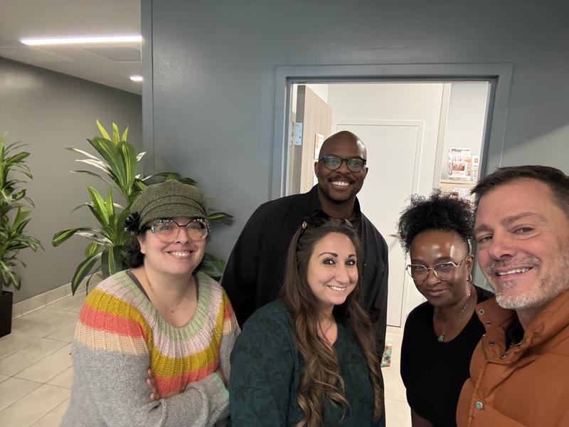 Christopher Laurent with a project team in a new building lobby