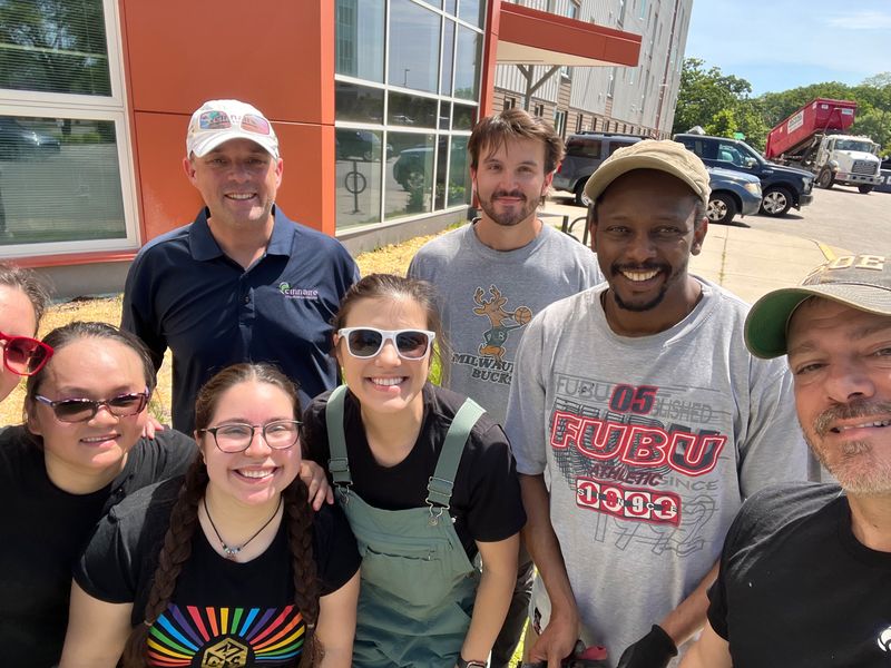 Christopher Laurent with colleagues at a volunteer workday outside an apartment community